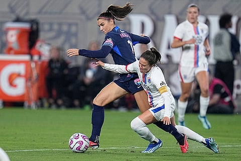 Alex Morgan Retires: San Diego Wave forward Alex Morgan, left, controls the ball as OL Reign defender Lauren Barnes defends